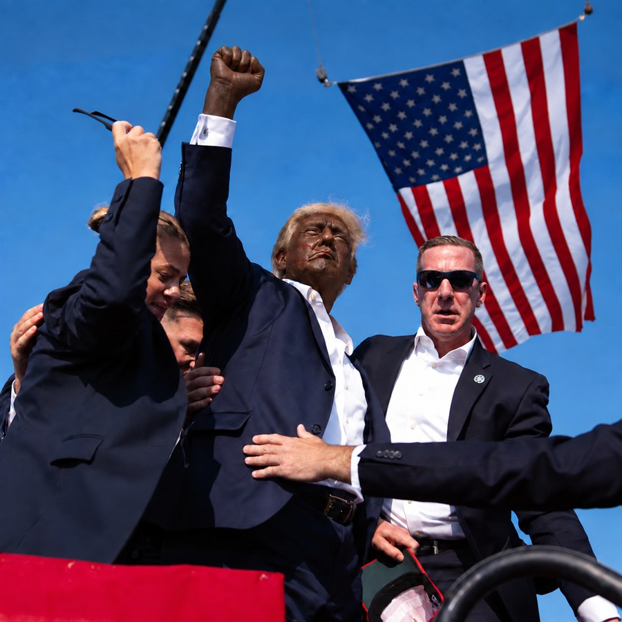 Fictional photo edit of Trump depicted as a Black man raising his fist among security agents.